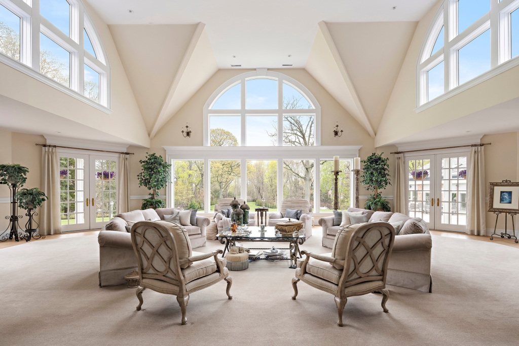A two-story great room with massive windows.