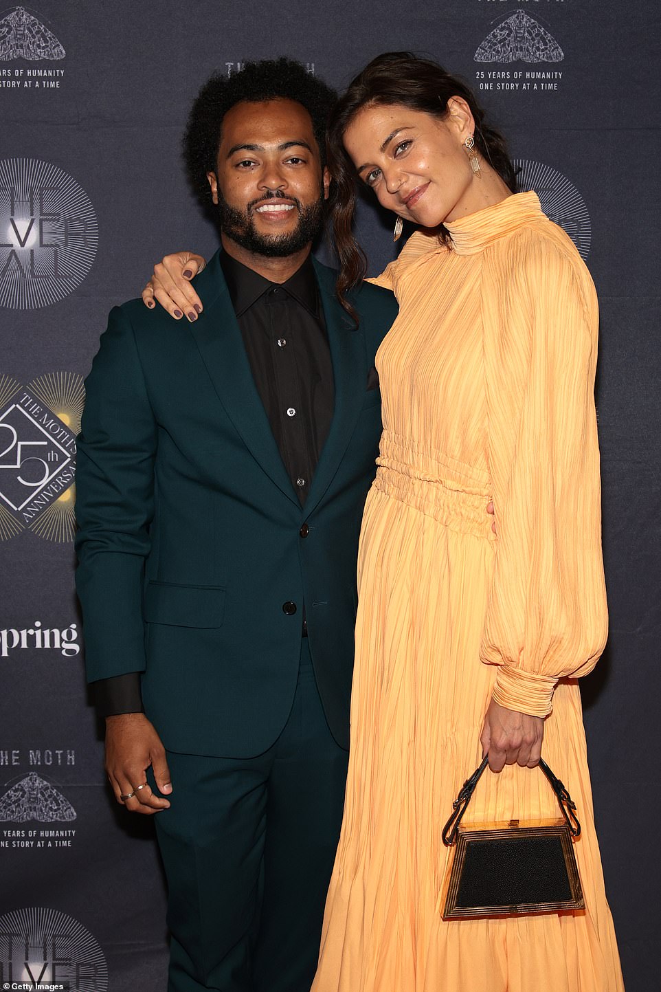 Stylish couple: The actress, 43, looked elegant in an ankle-length, peach-colored, pleated, high-necked dress, which she paired with black toe-ring heels and a chic art deco purse, while her boyfriend, 33, looked dapper in a forest green suit and black shirt