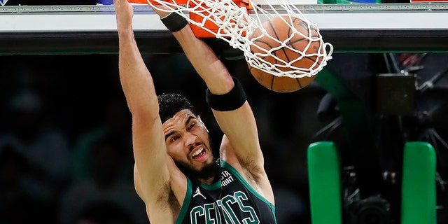 Boston Celtics' Jayson Tatum dives in during the first half of Game 6 of the Eastern Conference NBA Basketball Playoff Finals Friday, May 27, 2022 in Boston against the Miami Heat.  (AP Photo/Michael Dwyer)