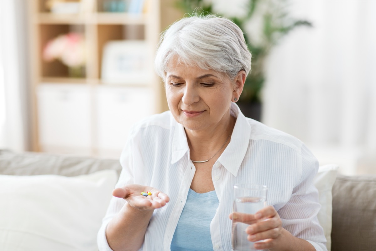 elderly woman taking pills