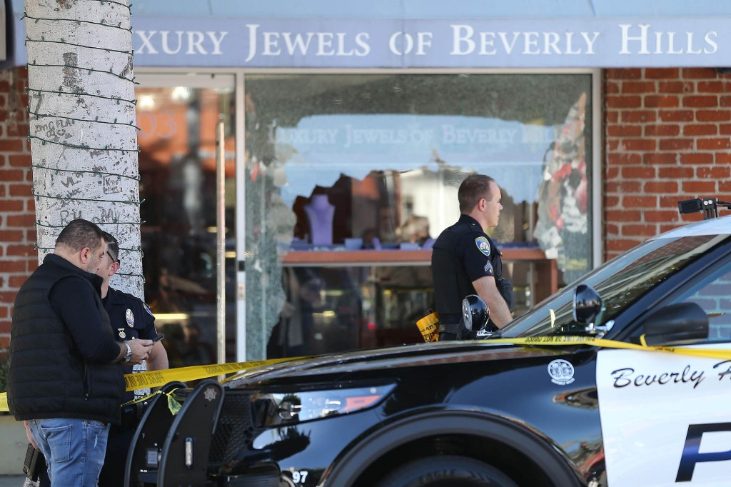 Police officers in Beverly Hills stand outside a robbed jewelry store.