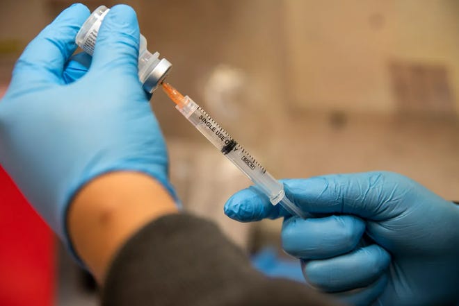 A nurse prepares a dose of the COVID-19 vaccine March 16 at a mobile health clinic in Los Angeles.