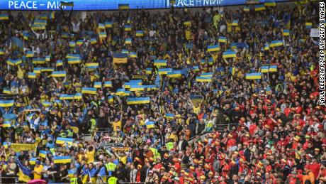 Ukraine fans wave their country's flag at the Cardiff City Stadium. 