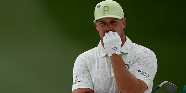 Bryson DeChambeau waits to make his shot into the seventh bunker during the second round of the Masters golf tournament on Friday, April 8, 2022 in Augusta, Georgia.