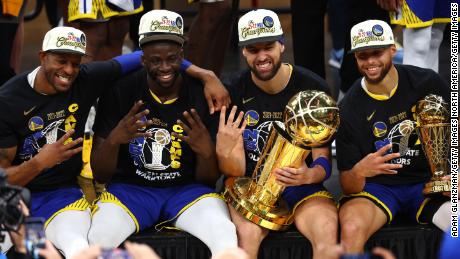 Andre Iguodala, Draymond Green, Klay Thompson and Curry pose for a photo after defeating the Boston Celtics in Game 6 of the 2022 NBA Finals.