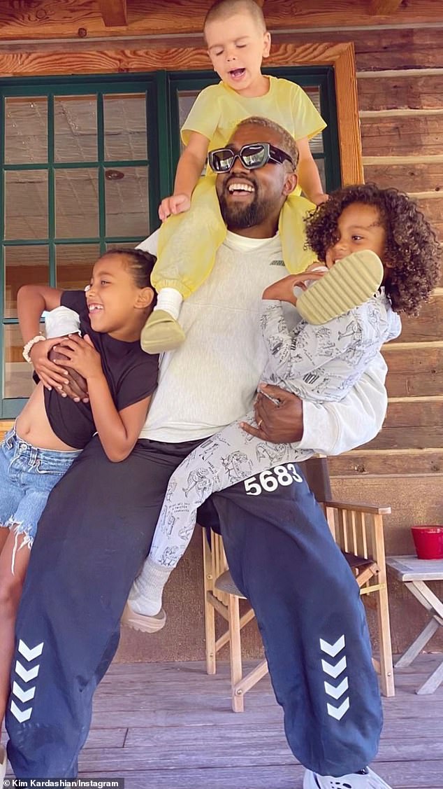 'Happy Father's Day, Ye!'  Kim also posted a picture of the 45-year-old rapper-designer carrying nephew Reign Disick, seven, on her shoulders as he hugged North and Saint
