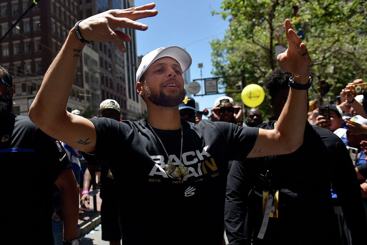 Stephen Curry exits his bus during the Warriors Victory Parade to interact with fans on Market Street. 