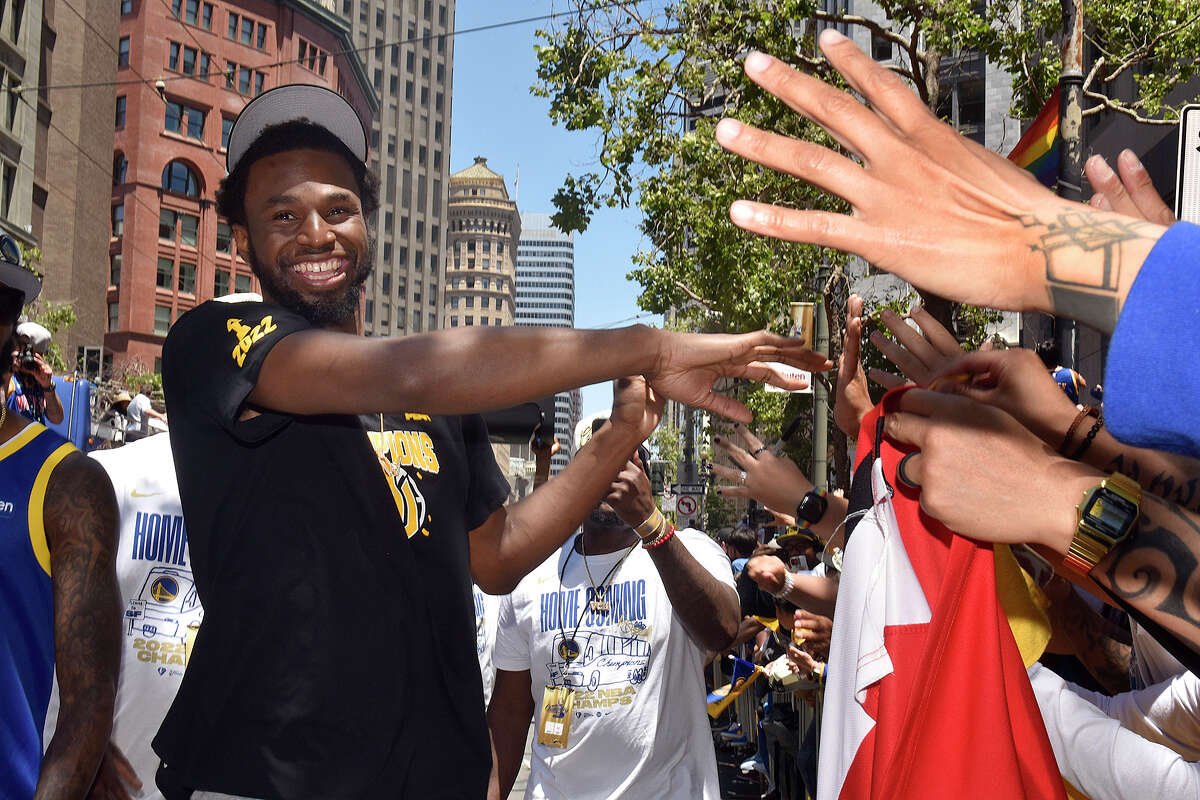 Warriors star Andrew Wiggins exits his bus to interact with fans on Market Street during the Victory Parade on Monday June 20, 2022. 