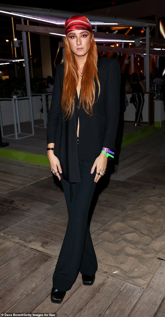 Chic: Elsewhere, fashion designer Harris Reed, 26, looked incredible in a longline black blazer and flared trousers