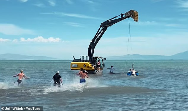 People rush to help Wittek after he collided with the excavator's arm and fell into the water