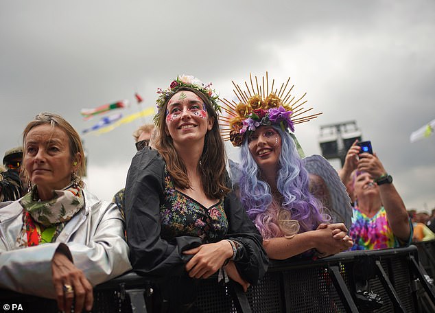 Music fans squeeze right to the barrier in front of the crowd during a Rufus Wainwright performance in Glastonbury