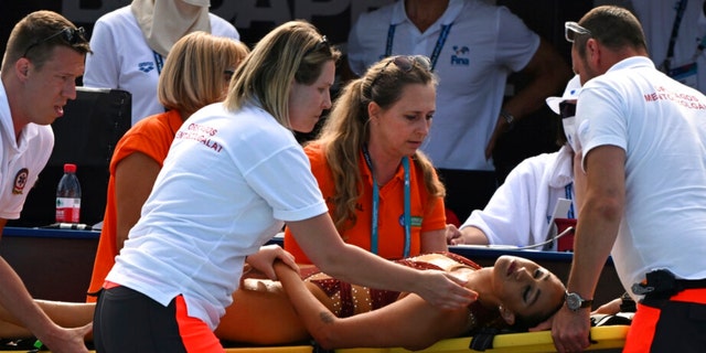 Anita Alvarez of the United States is carried out of the pool on a stretcher after swimming during the solo free final of artistic swimming at the 19th FINA World Championships in Budapest, Hungary, Wednesday, March 22. 