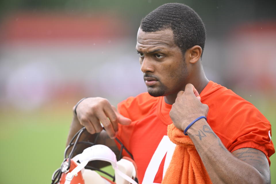 Cleveland Browns quarterback Deshaun Watson walks onto the field during an NFL football practice session at the team's training facility Wednesday, June 1, 2022, in Berea, Ohio.  (AP Photo/David Richard)