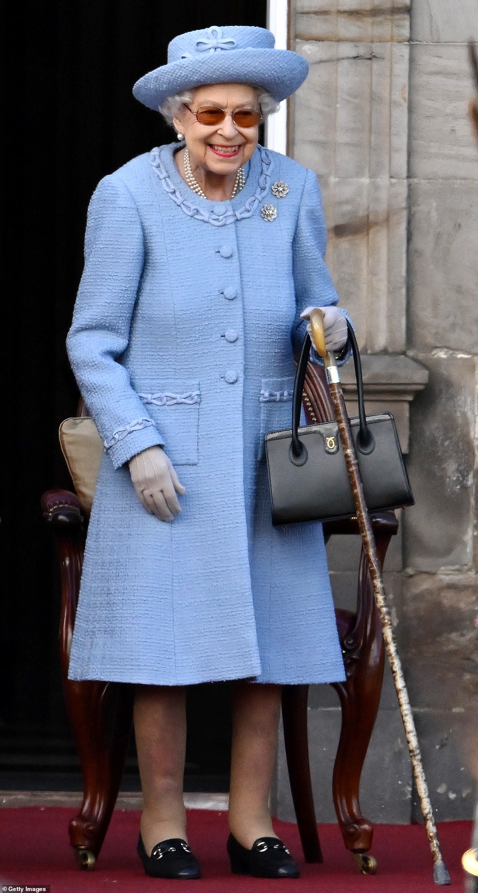 Radiant blue!  The Queen smiles as she takes part in the Royal Company of Archers' Reddendo parade in the gardens of the Palace of Holyroodhouse