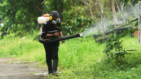 A worker sprays an insecticide to control dengue fever in Singapore, July 6, 2021.