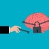 This cartoon shows a brain with a lock around it and a man holding a key