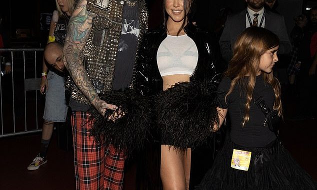 Loved: Kourtney Kardashian showed off a hint of her fetish-style bra while on a date night with husband Travis Barker at the Machine Gun Kelly concert at The Forum in Los Angeles on Wednesday