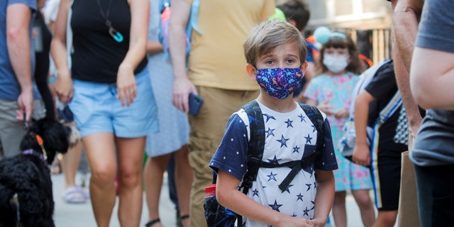 A child wears a face mask on the first day of school in New York City amid the coronavirus (COVID-19) pandemic in Brooklyn, NY September 2021. 