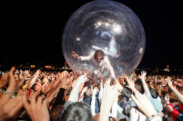 Coyne in his clear plastic bubble, held up by the audience's hands