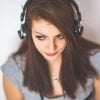 This shows a woman with headphones